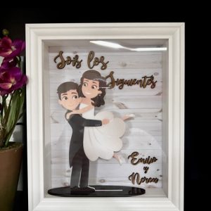 Novios en brazos en marco "sois los siguientes"